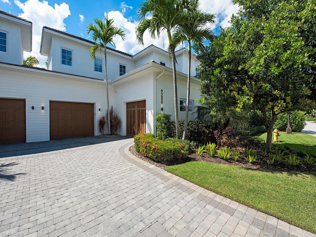 9200 Mercato Way Naples, FL 34108 - Photo 1 of 13 a front view of a house with a yard and garage