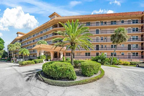 a view of a palm trees in front of a building