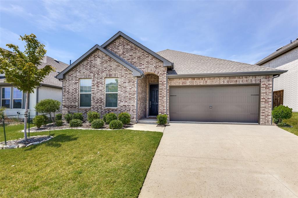 3817 Primrose Drive Aubrey, TX 76227 - Photo 1 of 39 a front view of a house with a yard and garage