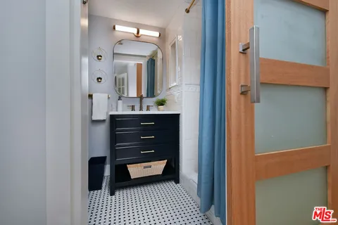 a bathroom with a bath tub with a shower