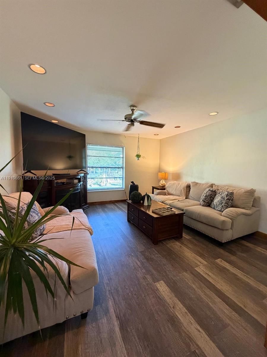 19820 Southwest 244th Street Homestead, FL 33031 - Photo 16 of 99 a living room with furniture and a flat screen tv