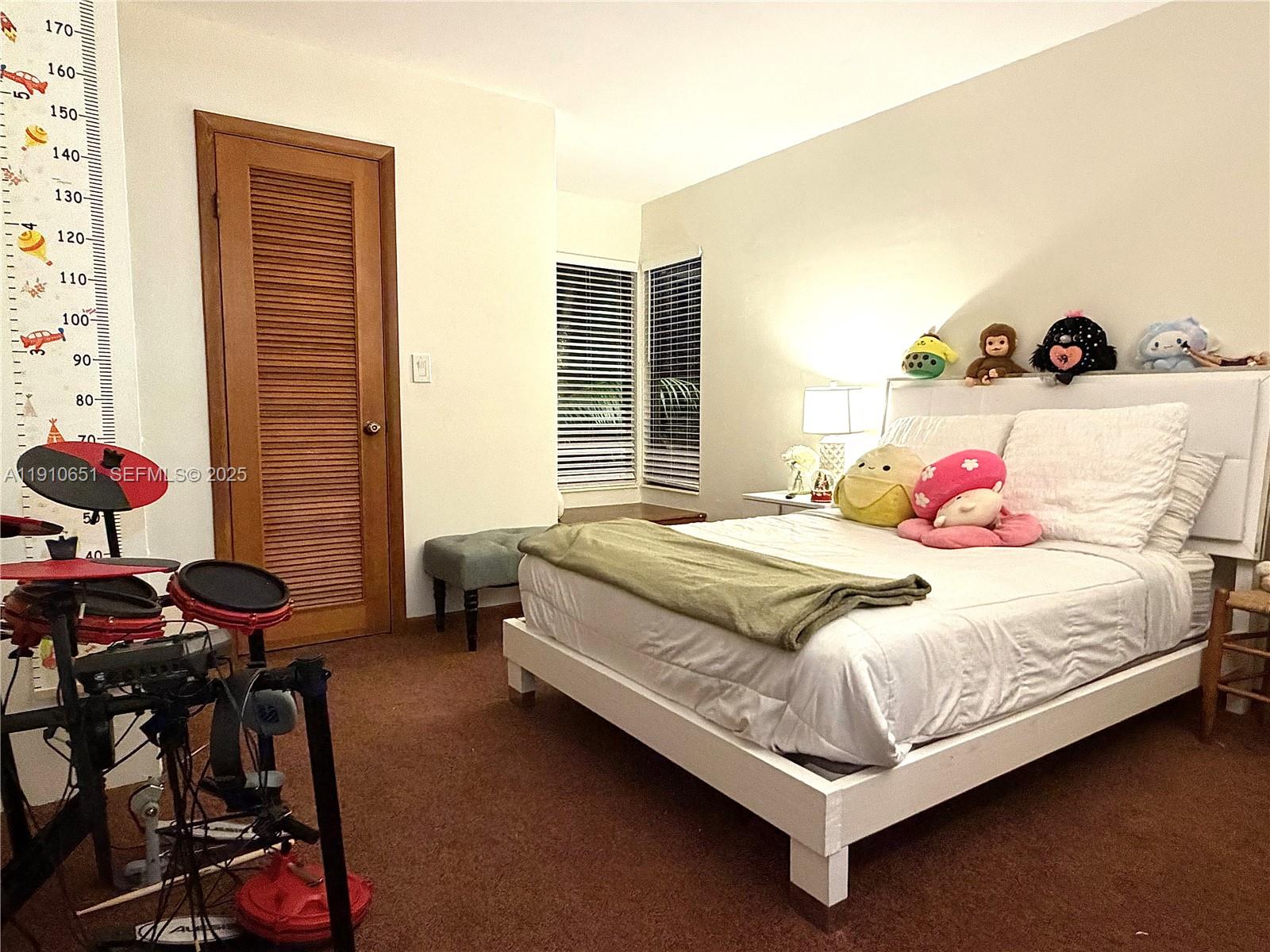 19820 Southwest 244th Street Homestead, FL 33031 - Photo 25 of 99 a bedroom with a bed and dresser