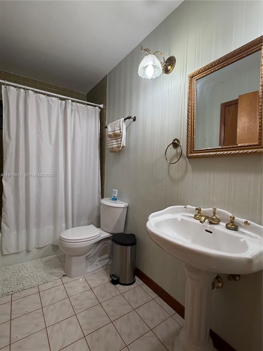 19820 Southwest 244th Street Homestead, FL 33031 - Photo 27 of 99 a bathroom with a sink a toilet and mirror
