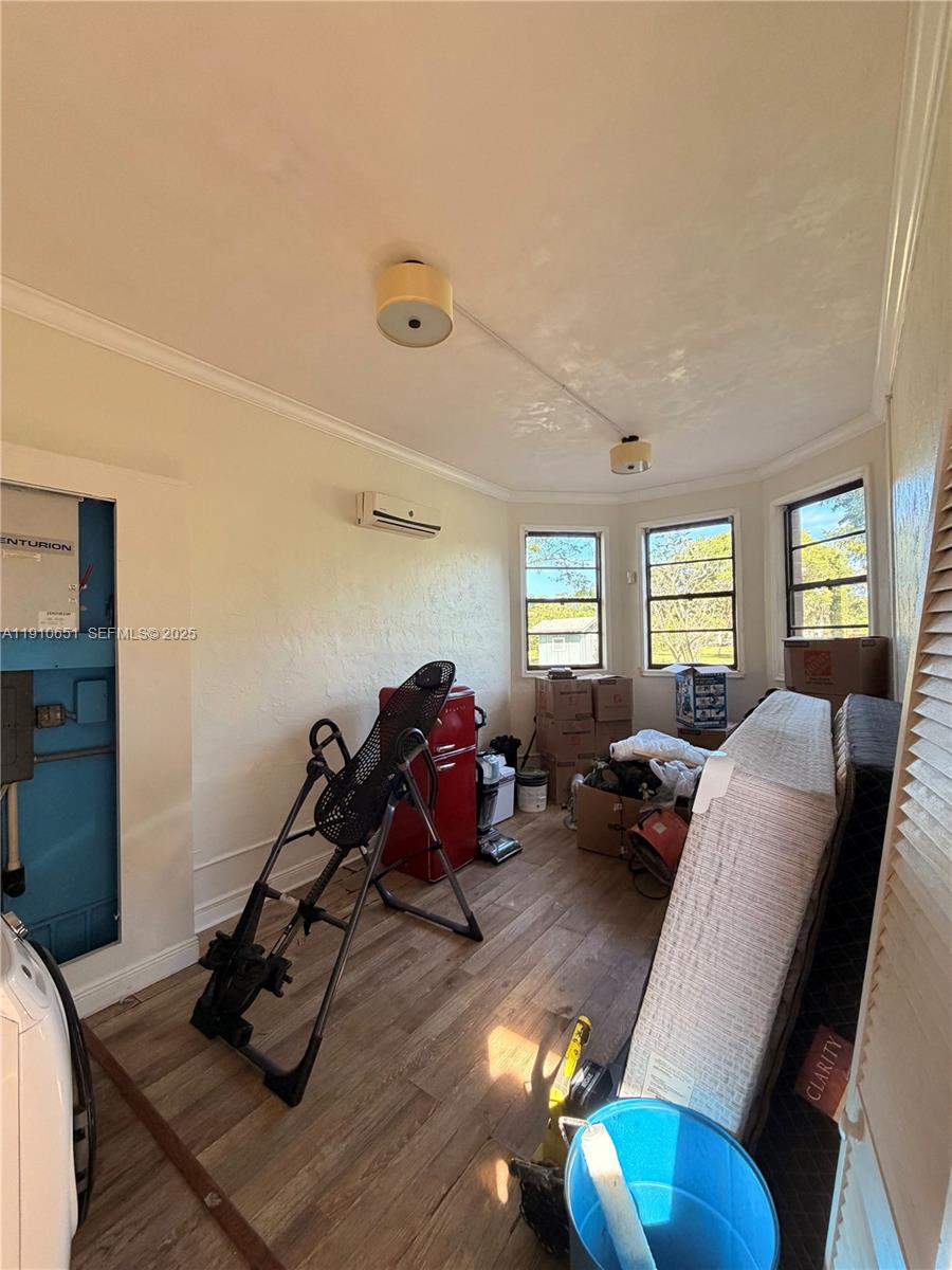 19820 Southwest 244th Street Homestead, FL 33031 - Photo 40 of 99 a living room with furniture gym equipment and a window
