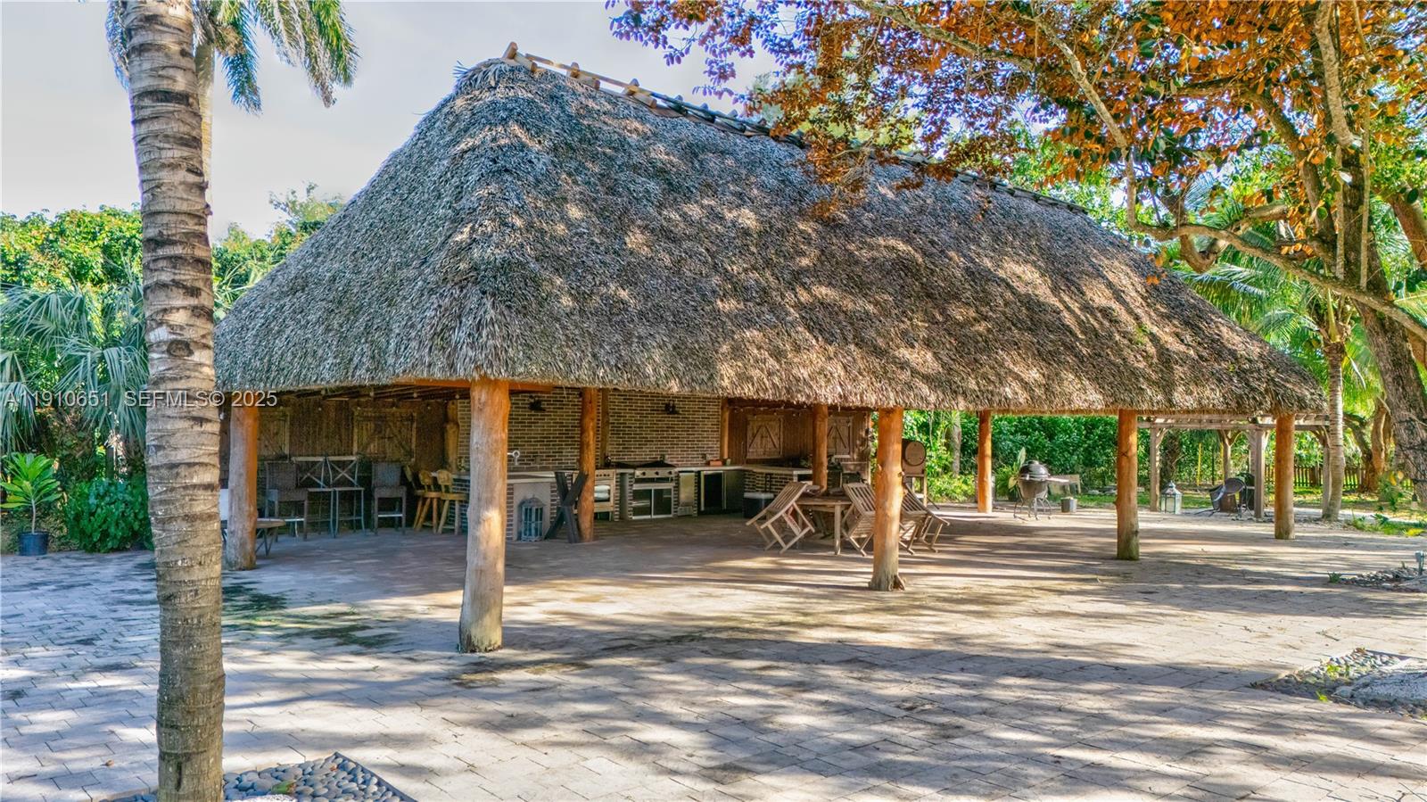 19820 Southwest 244th Street Homestead, FL 33031 - Photo 47 of 99 a view of a house with a patio and a yard