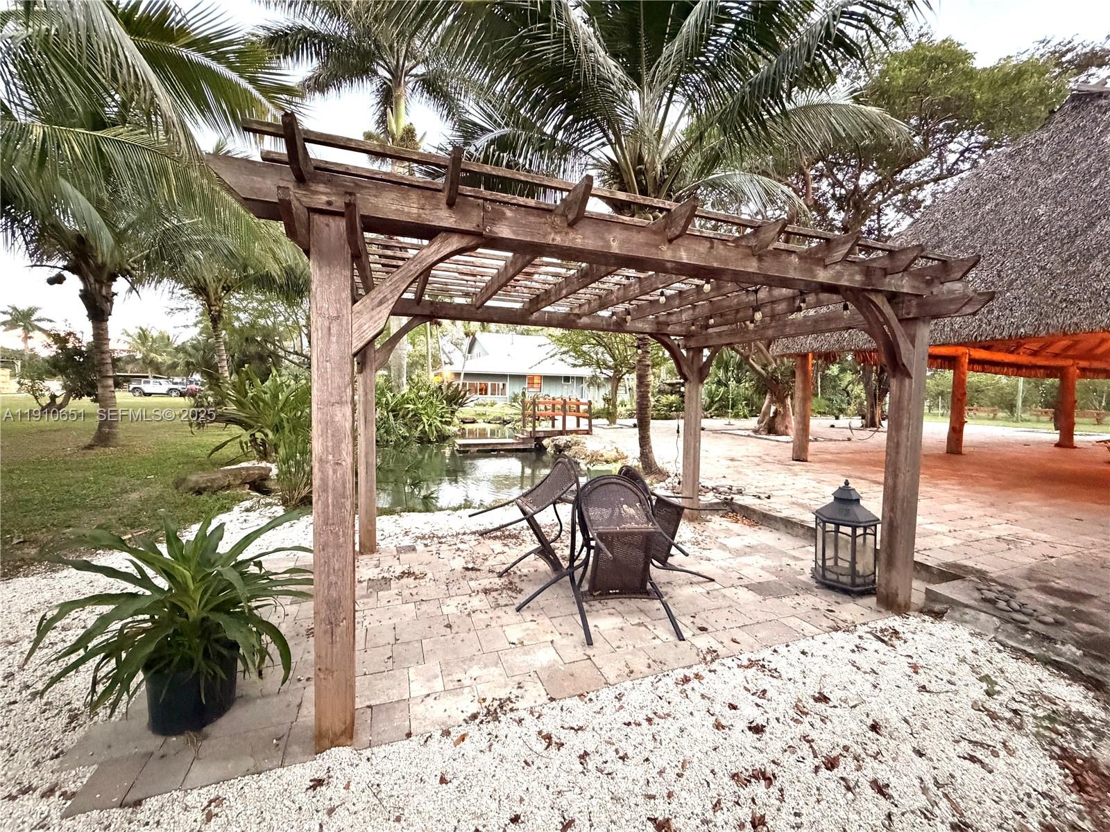 19820 Southwest 244th Street Homestead, FL 33031 - Photo 50 of 99 a garden view with a sitting space