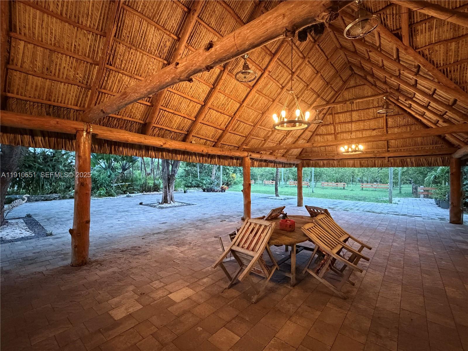 19820 Southwest 244th Street Homestead, FL 33031 - Photo 53 of 99 a backyard of a house with yard and outdoor seating