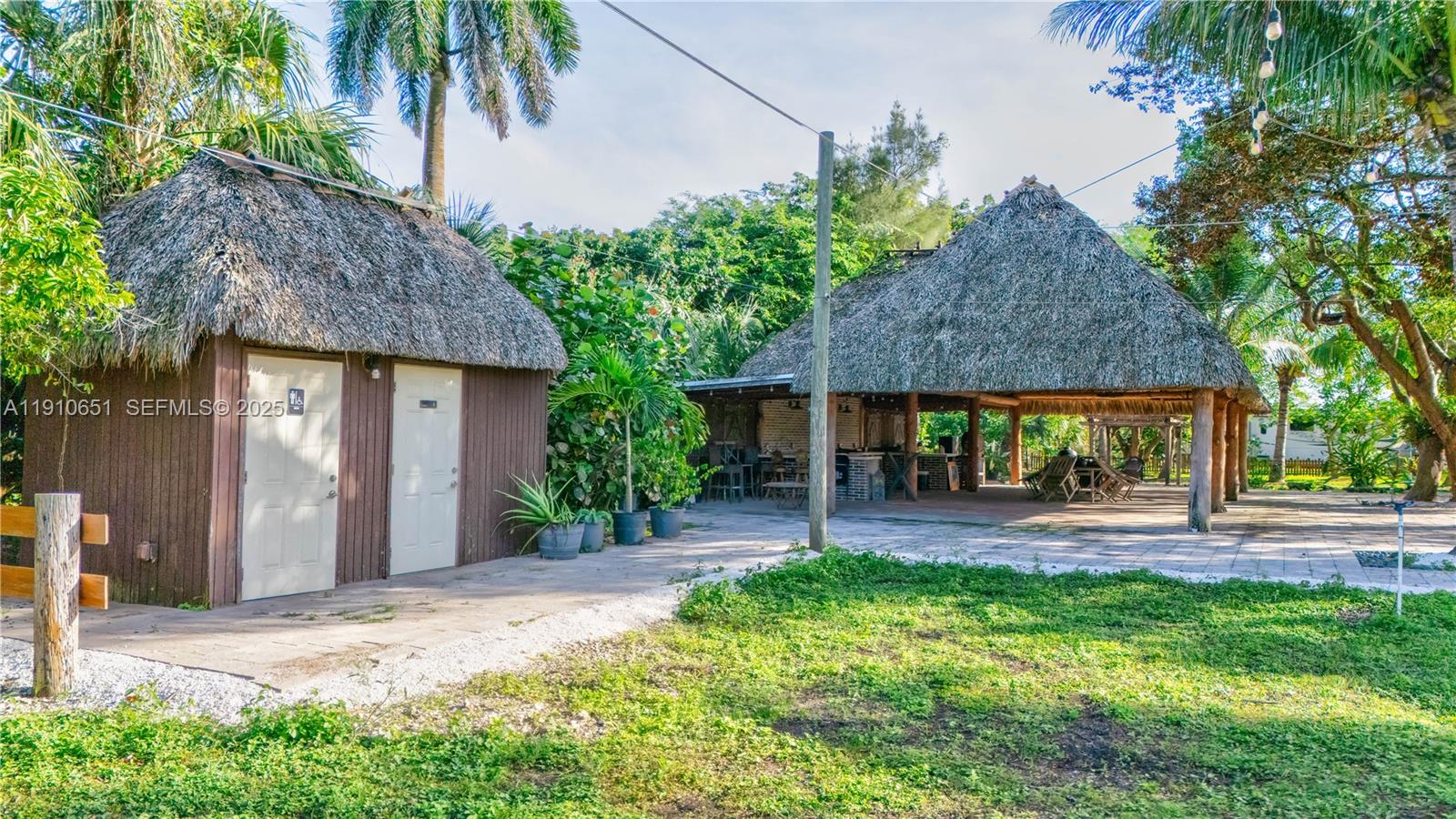 19820 Southwest 244th Street Homestead, FL 33031 - Photo 59 of 99 a front view of a house with a yard and porch
