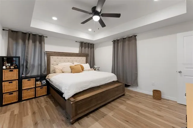 a bedroom with a bed and a ceiling fan