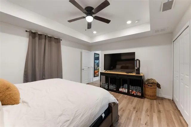 a bedroom with a bed and a flat screen tv