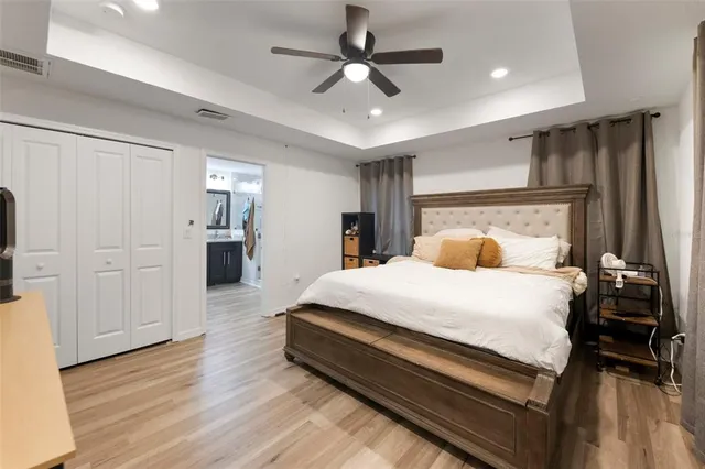 a bedroom with bed and wooden floor