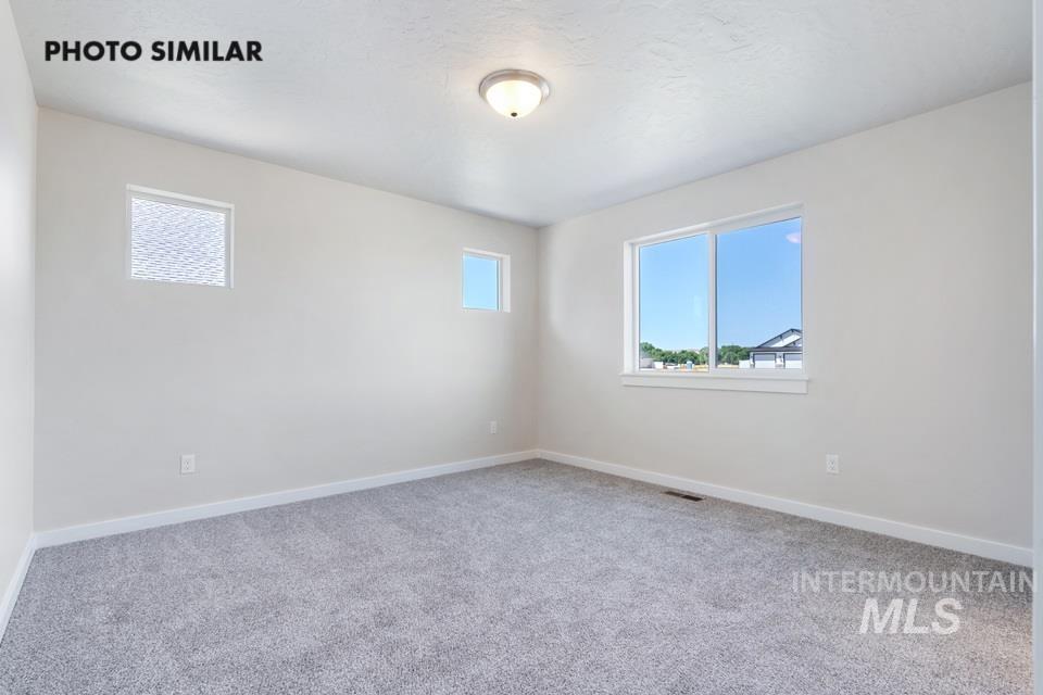 1693 Rapid Road Emmett, ID 83617 - Photo 16 of 28 Spacious room featuring neutral carpeting and light-toned walls