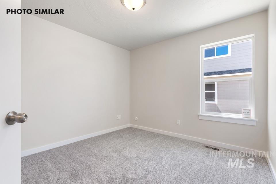 1693 Rapid Road Emmett, ID 83617 - Photo 22 of 28 Neutral-toned room featuring light gray walls, plush gray carpeting, and white baseboards