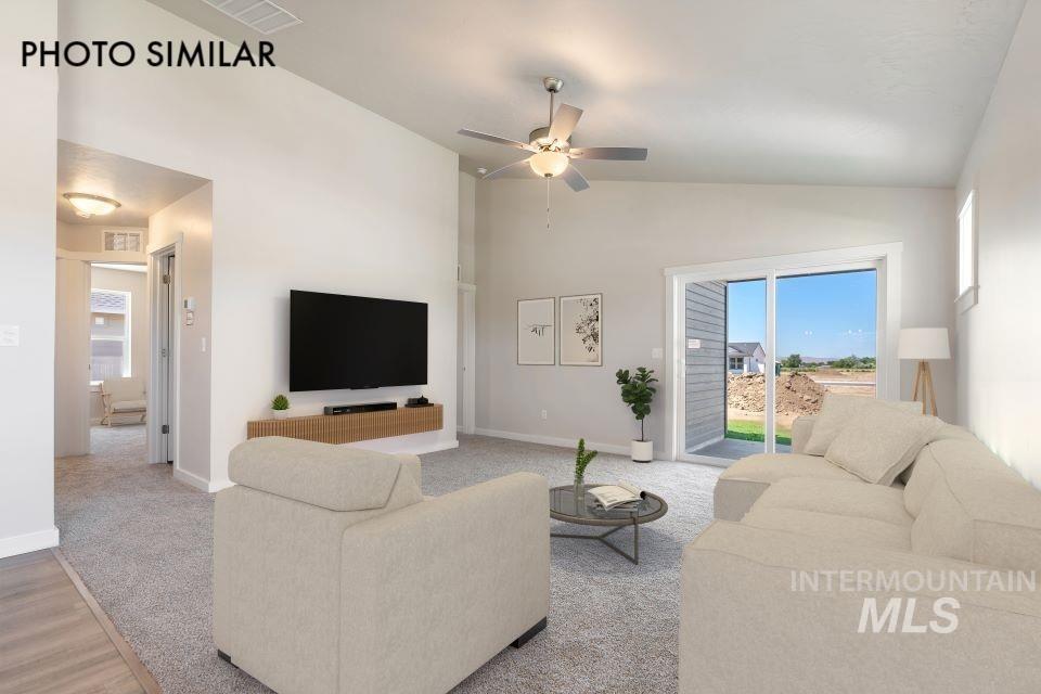 1693 Rapid Road Emmett, ID 83617 - Photo 3 of 28 Spacious living area featuring vaulted ceilings, a ceiling fan with integrated lighting, and carpet flooring