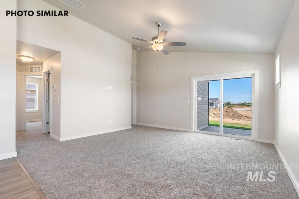 1693 Rapid Road Emmett, ID 83617 - Photo 4 of 28 Spacious room featuring light gray carpeting, tall white baseboards, and a contemporary ceiling fan with integrated lighting