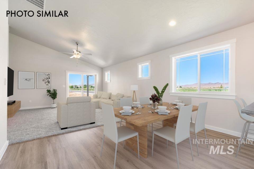 1693 Rapid Road Emmett, ID 83617 - Photo 5 of 28 Bright dining area featuring wood-finish flooring, a large window, and recessed lighting