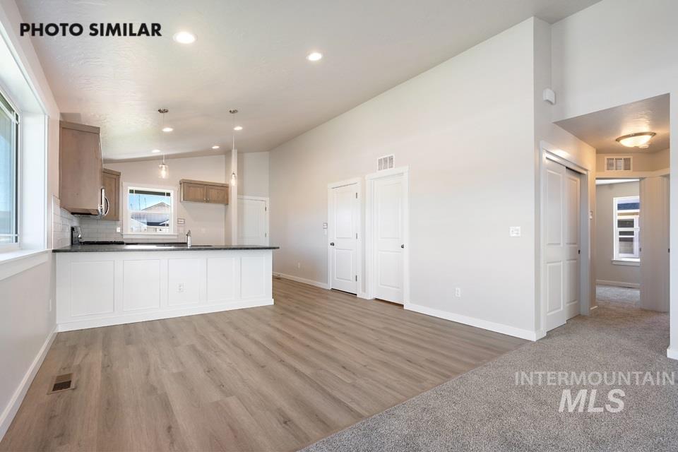 1693 Rapid Road Emmett, ID 83617 - Photo 7 of 28 Open-concept living area with wood-finish flooring, recessed lighting, and a white paneled island