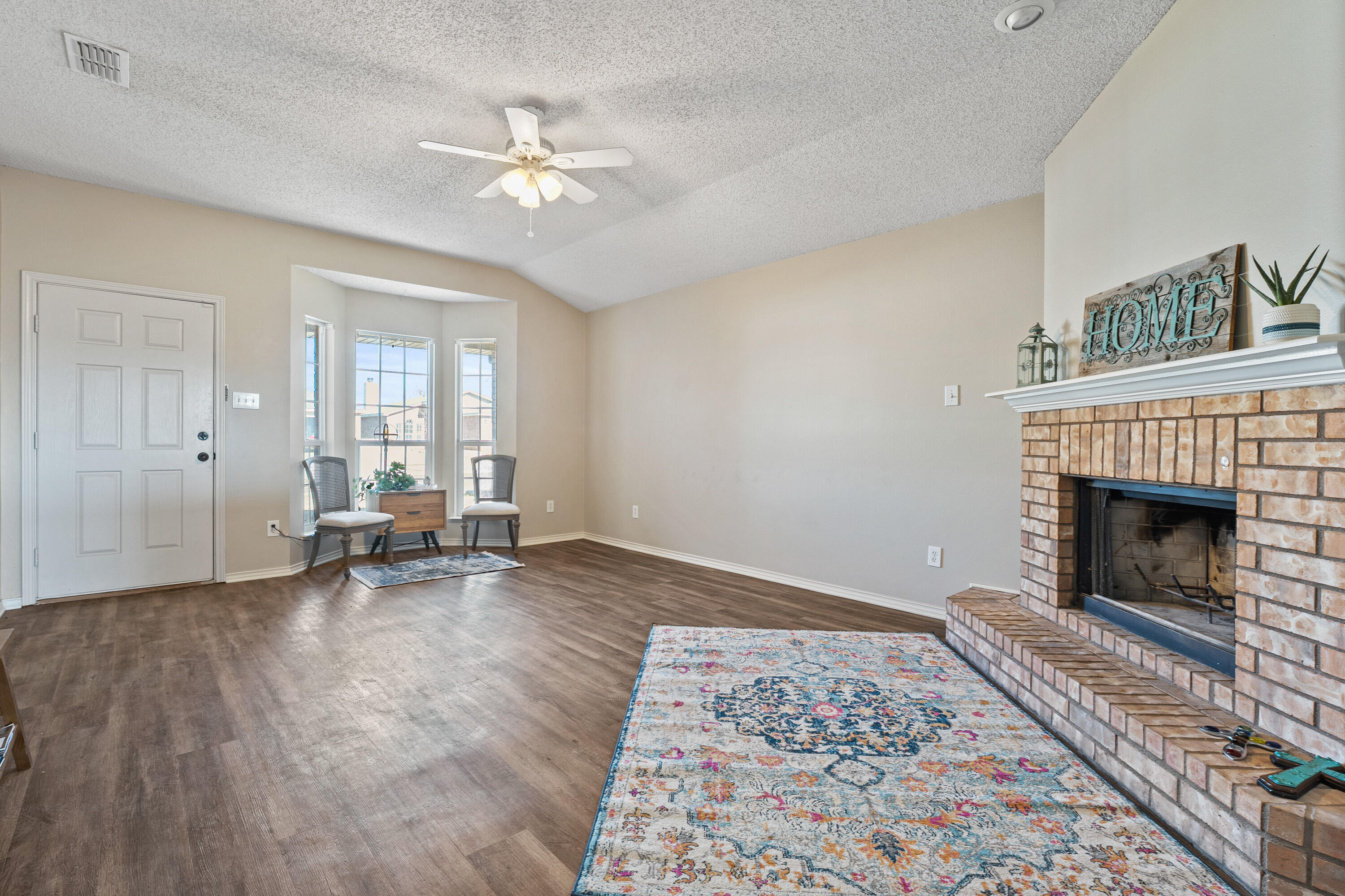 6517 91st Street Lubbock, TX 79424 - Photo 3 of 11 a living room with furniture and a fireplace