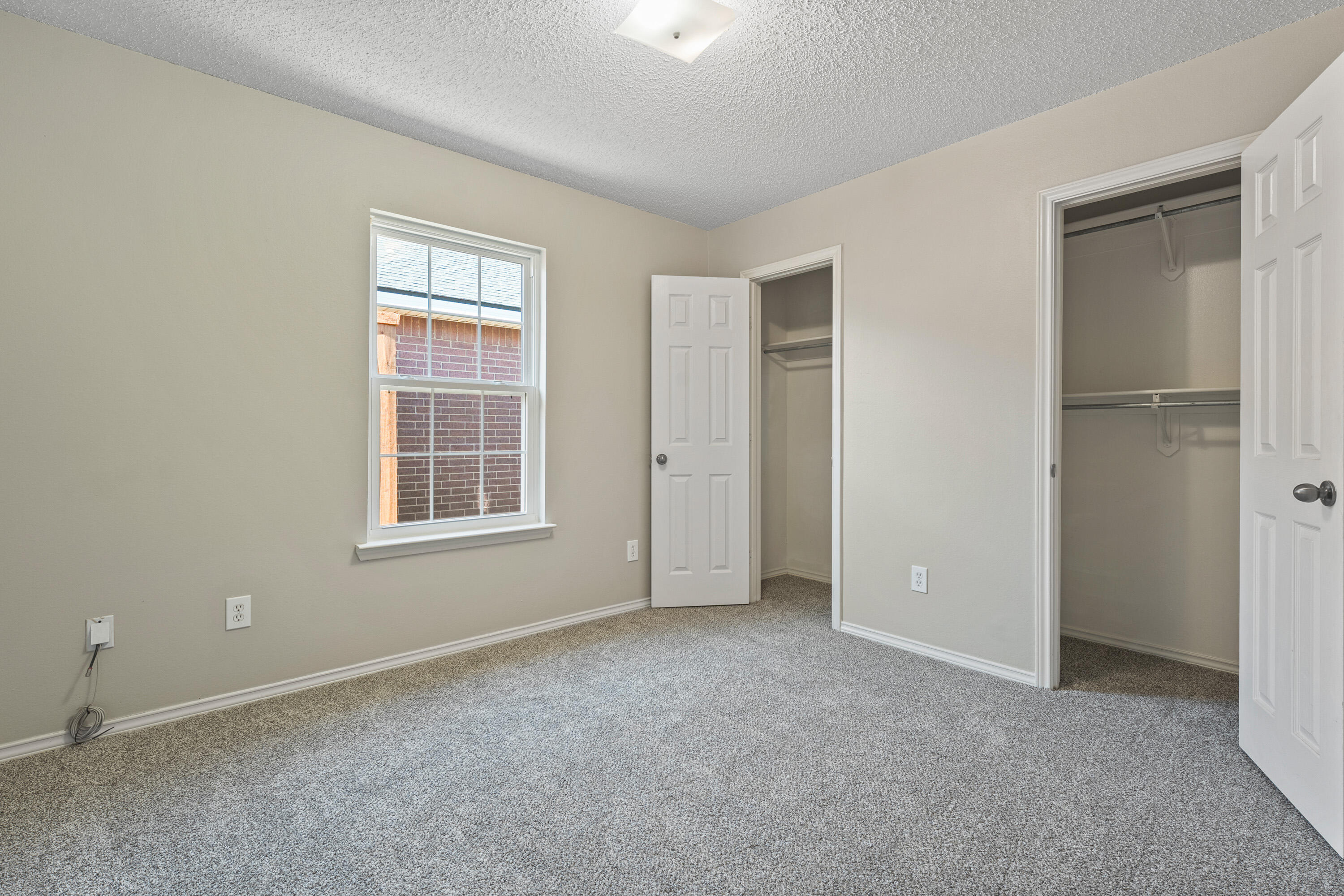 6517 91st Street Lubbock, TX 79424 - Photo 7 of 11 an empty room with windows and closet