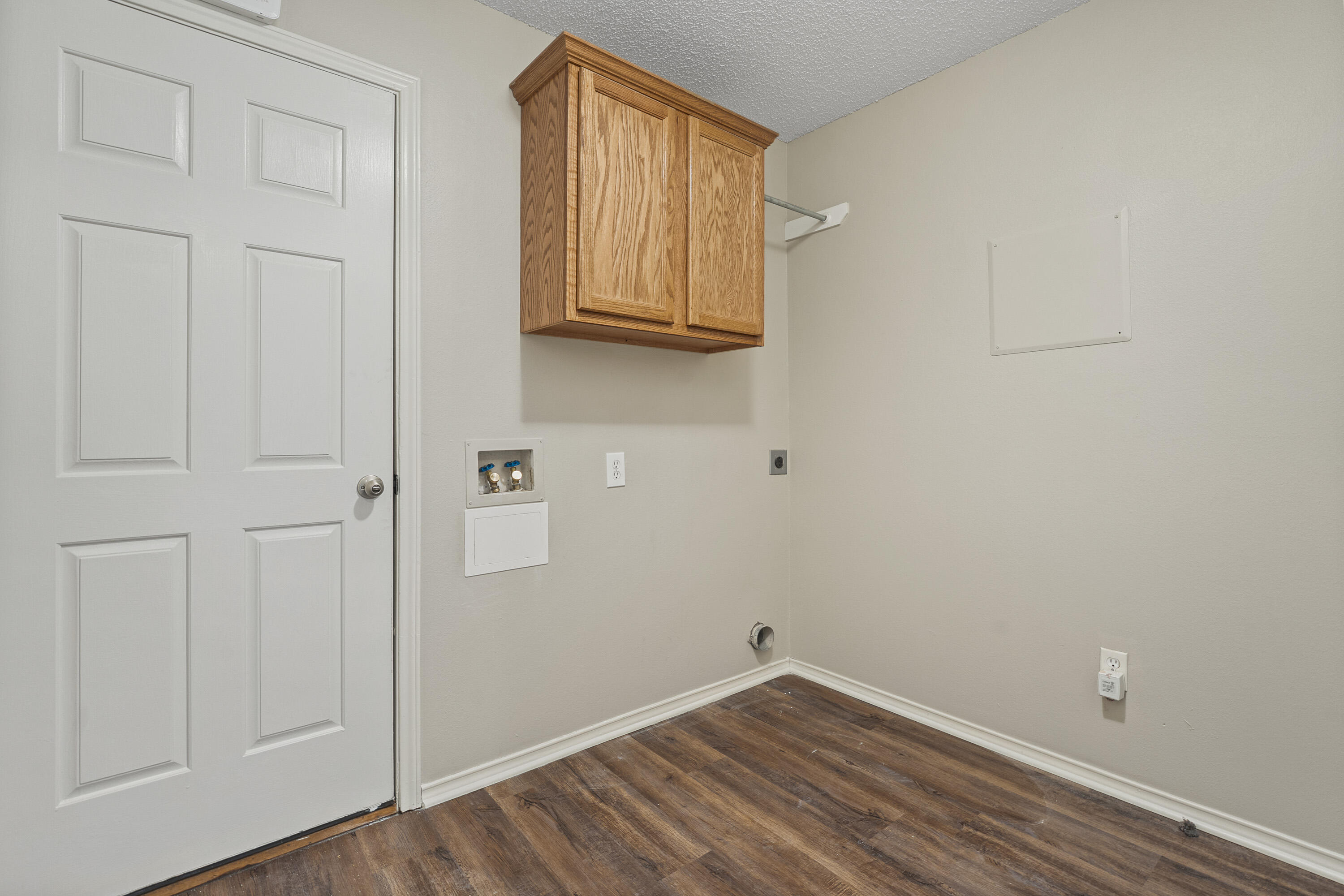 6517 91st Street Lubbock, TX 79424 - Photo 10 of 11 a view of a closet area with wooden floor