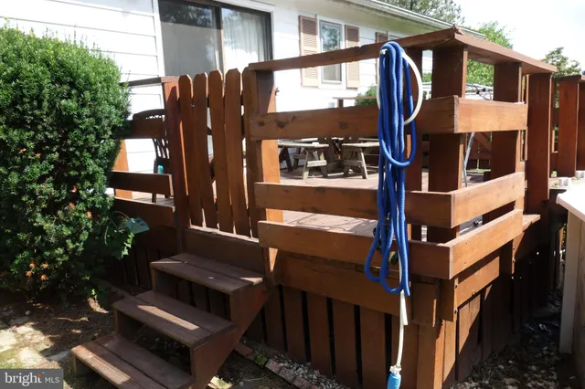 a view of a house with a yard and wooden fence