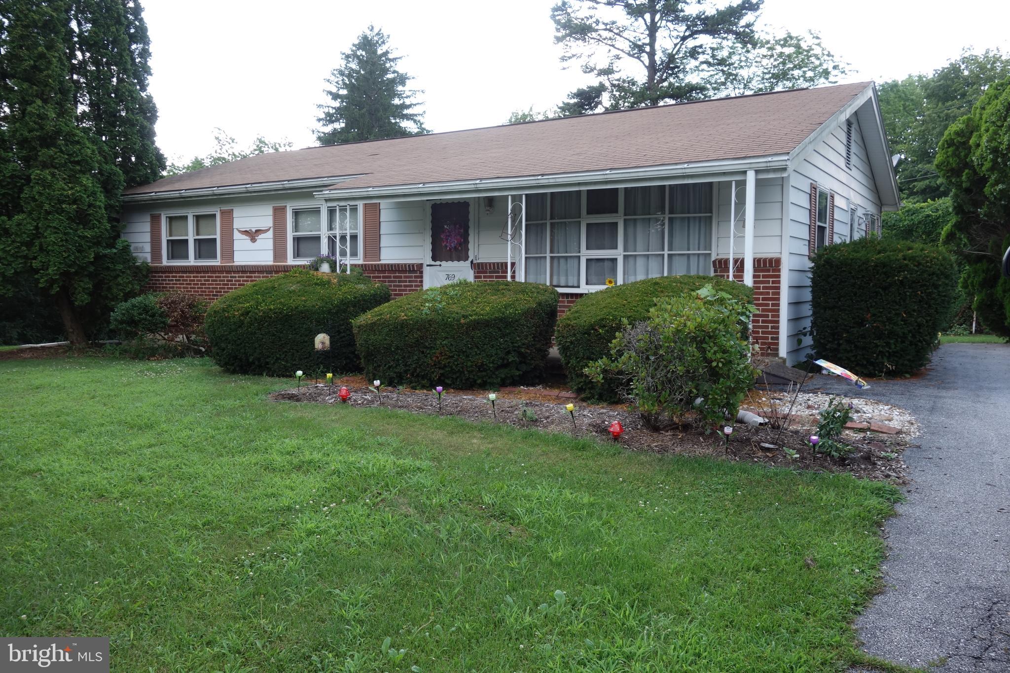 769 Knob Hill Road Fayetteville, PA 17222 - Photo 22 of 56 a front view of a house with a garden