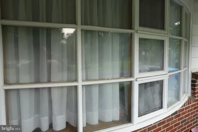 a view of a dining room with furniture and windows