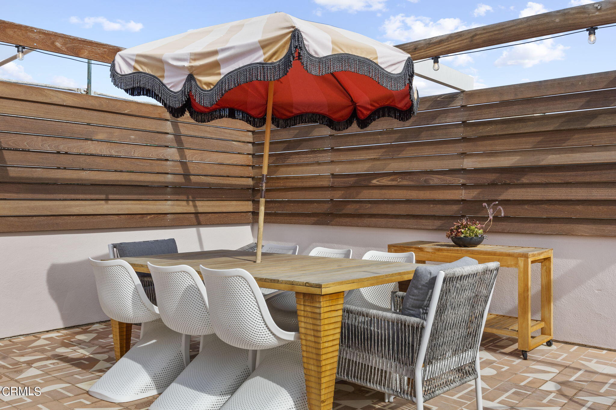 4136 Ocean Drive Oxnard, CA 93035 - Photo 43 of 58 a view of a patio with a table and chairs under an umbrella