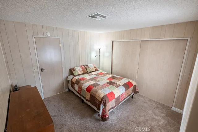 a bedroom with a bed and a mirror