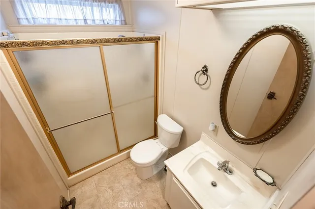 a bathroom with a sink mirror toilet and shower