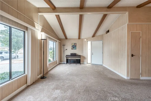 a view of livingroom with furniture staircase and front door