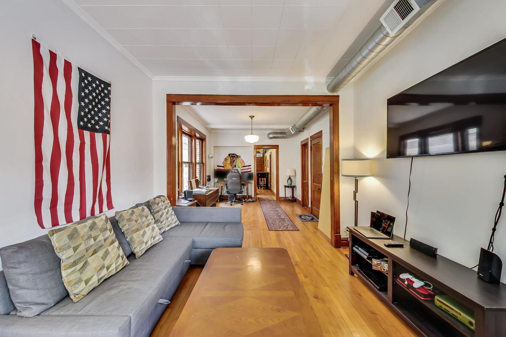 2145 West Thomas Street, Unit 2 Chicago, IL 60622 - Photo 2 of 14 a living room with furniture and a fireplace