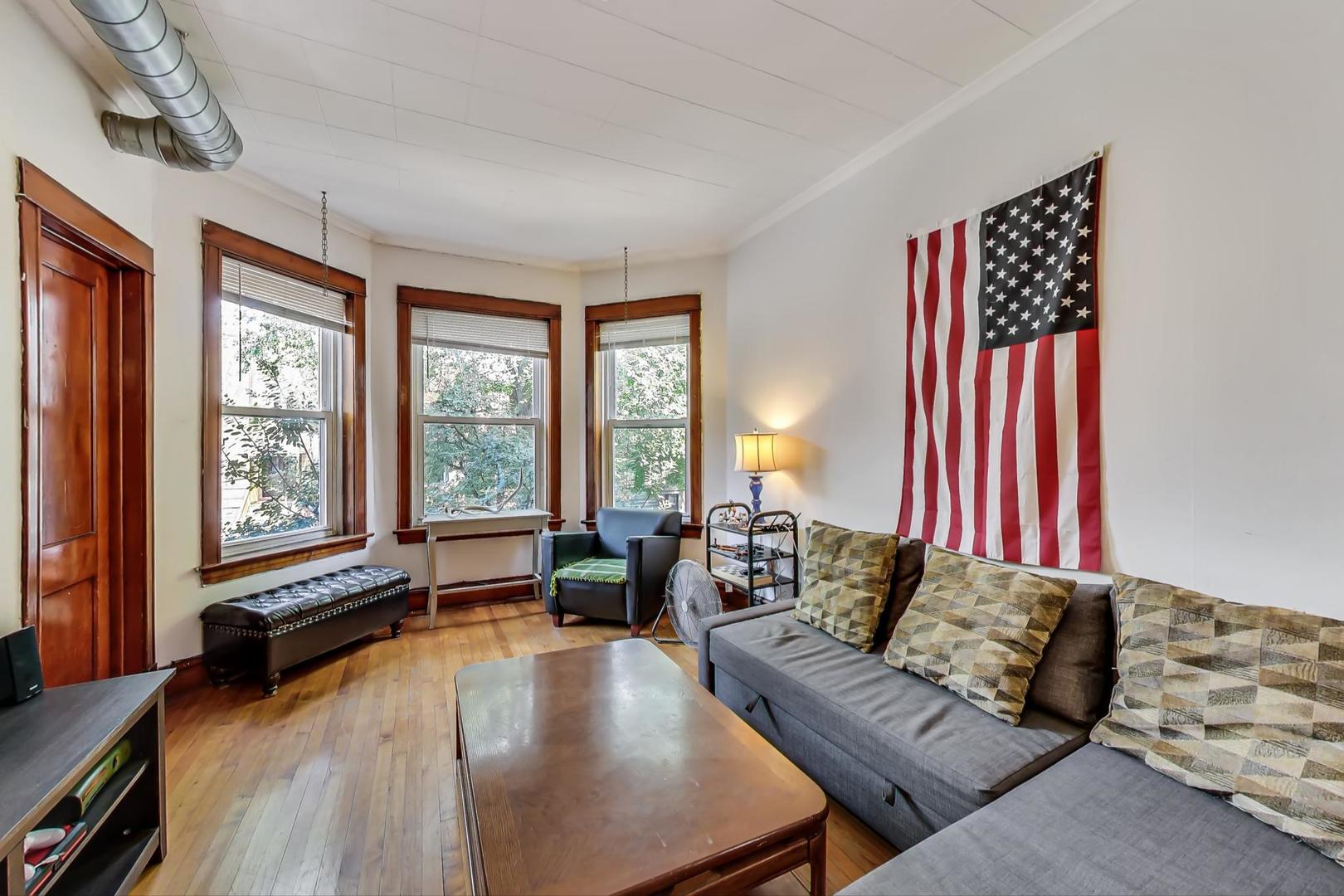 2145 West Thomas Street, Unit 2 Chicago, IL 60622 - Photo 3 of 14 a living room with furniture and a large window