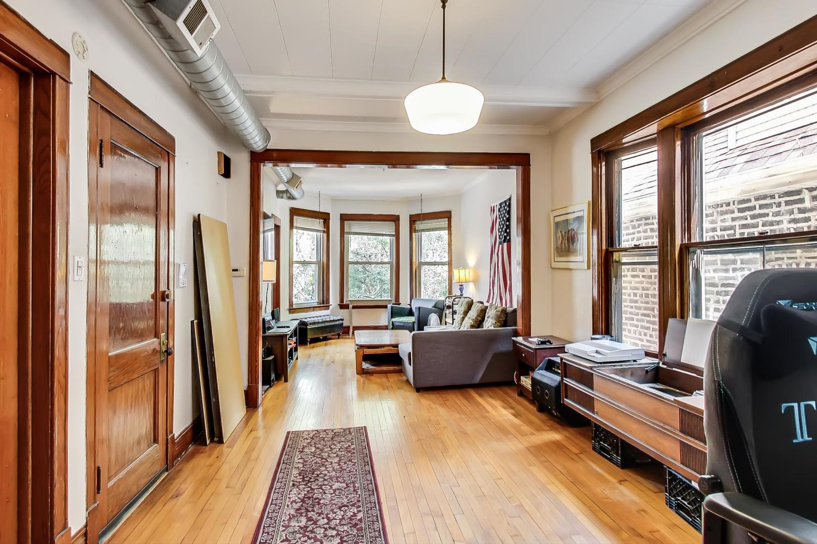 2145 West Thomas Street, Unit 2 Chicago, IL 60622 - Photo 7 of 14 a living room with furniture and a large window