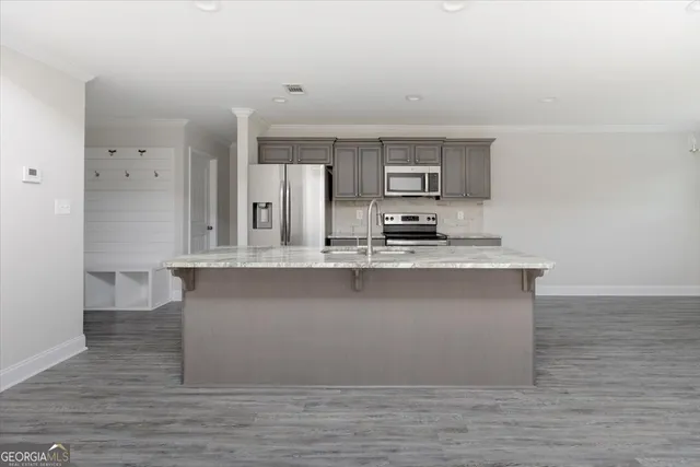 a kitchen with a stove top oven sink and cabinets