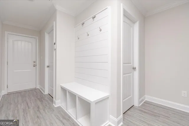 a view of an empty room with wooden floor