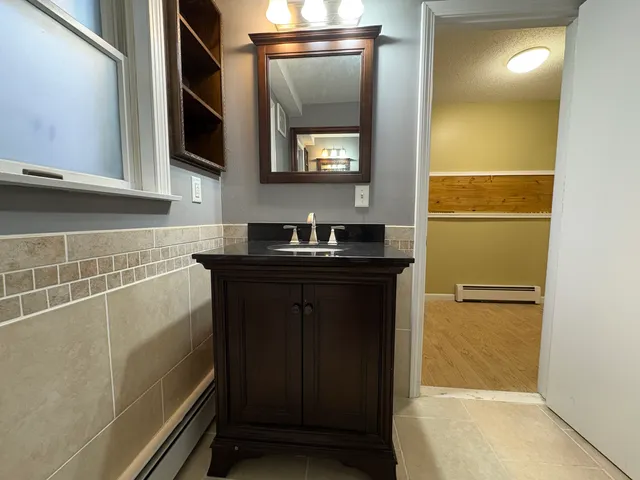 a bathroom with a sink a vanity and a mirror