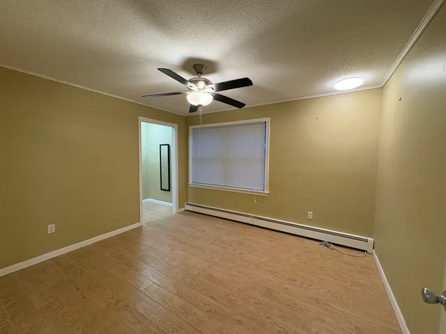 an empty room with a empty space and a ceiling fan