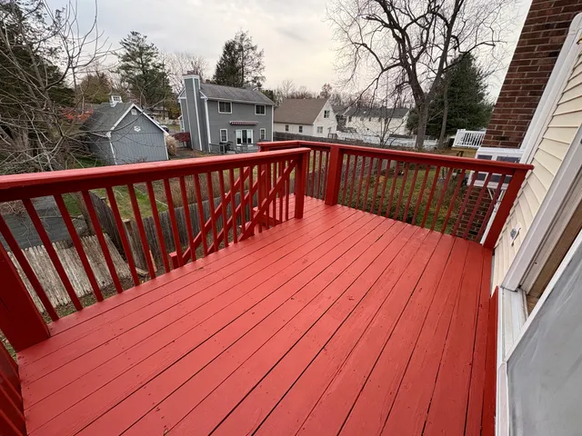 a balcony with wooden floor and fence