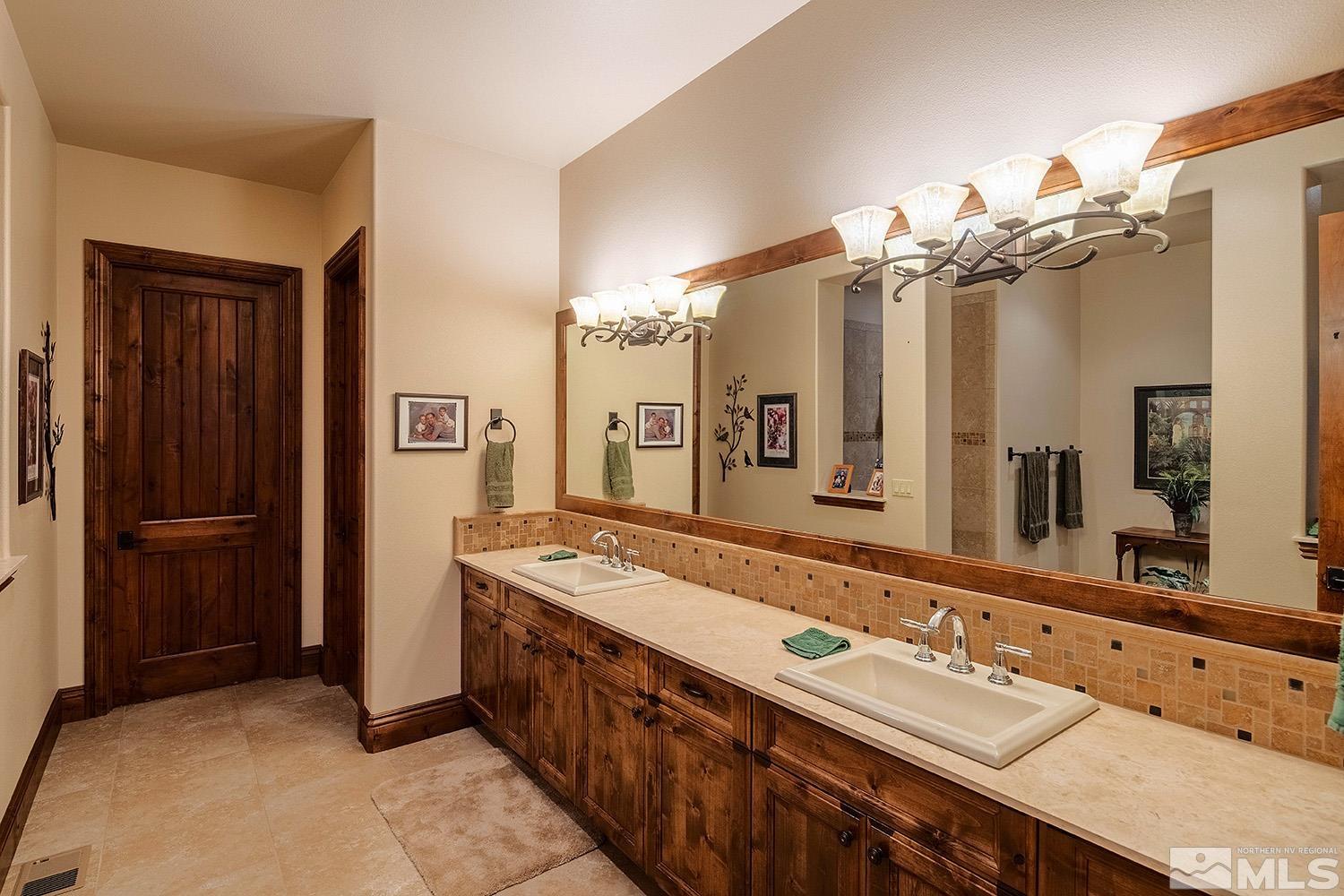 3745 Boulder Patch Reno, NV 89511 - Photo 12 of 40 a bathroom with a double vanity sink and a mirror