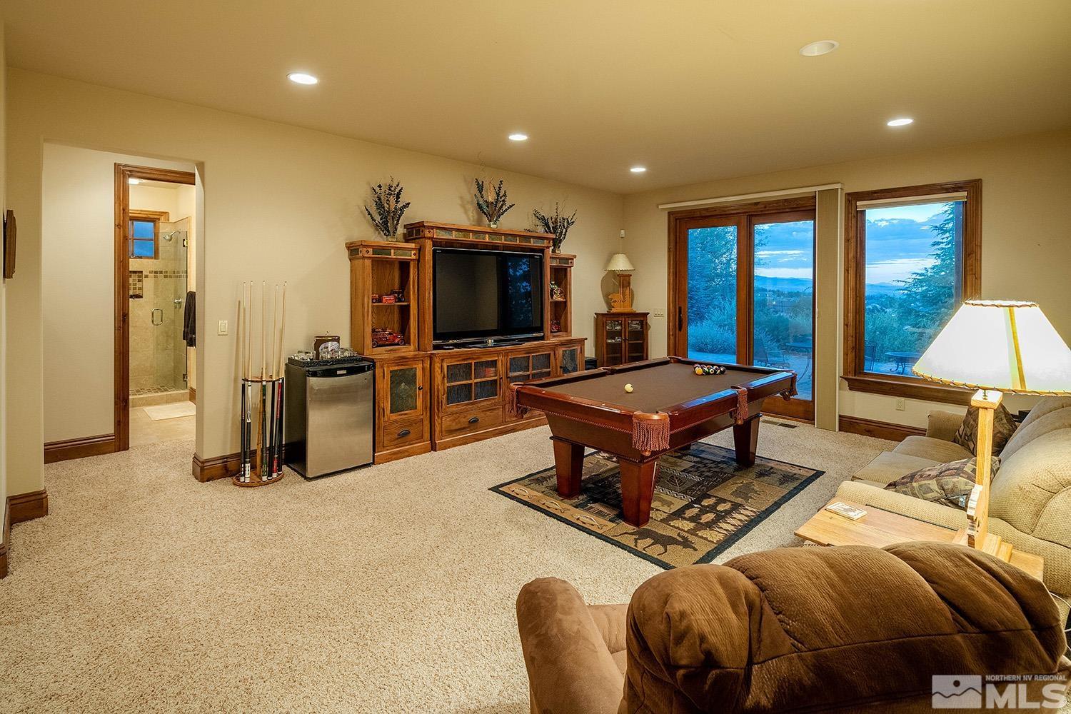 3745 Boulder Patch Reno, NV 89511 - Photo 18 of 40 a living room with furniture a flat screen tv and a large window