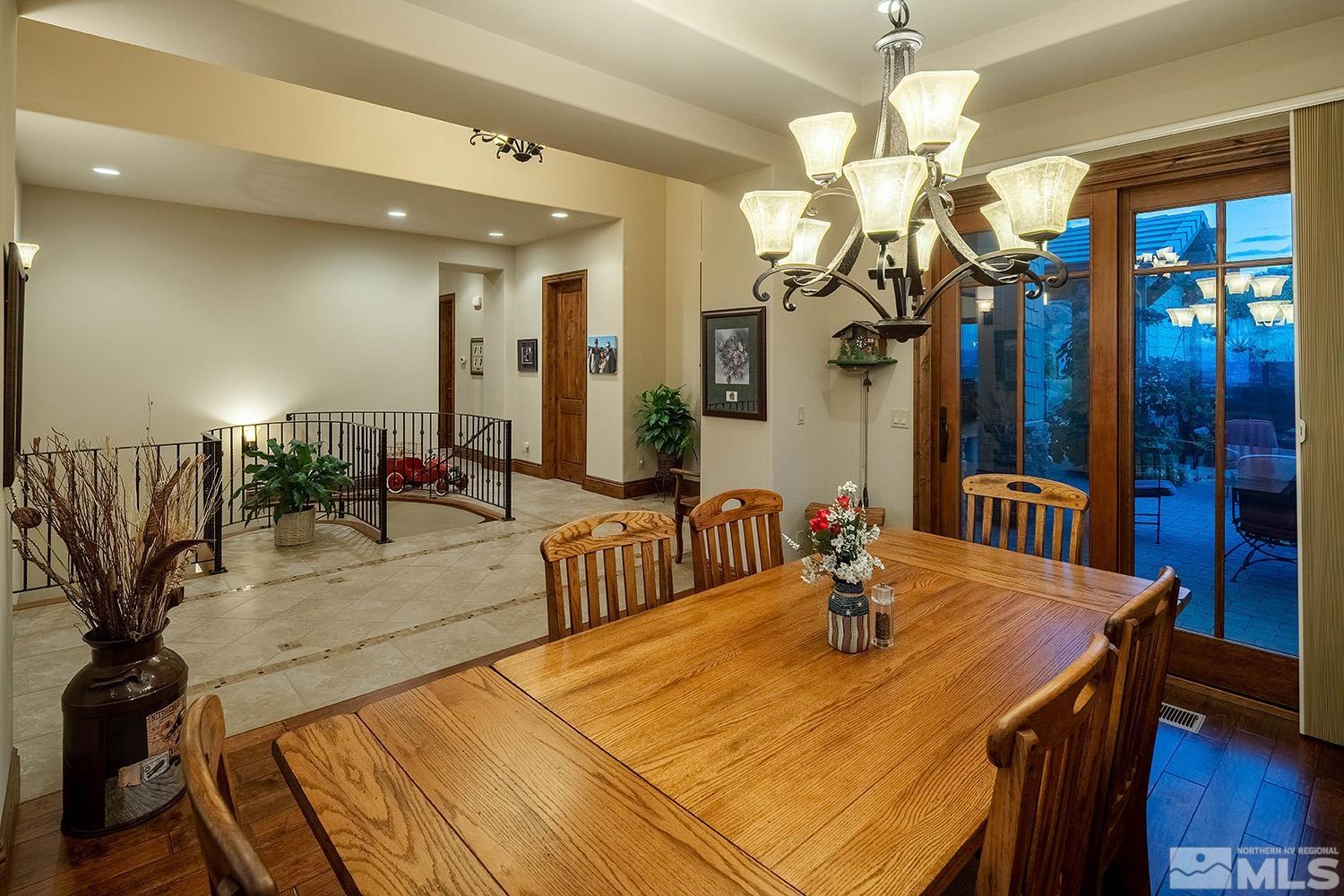 3745 Boulder Patch Reno, NV 89511 - Photo 6 of 40 a dining room with wooden floor a chandelier a wooden table and chairs