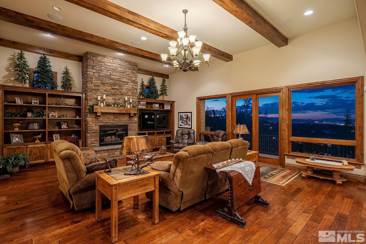 3745 Boulder Patch Reno, NV 89511 - Photo 10 of 40 a living room with furniture a chandelier and a flat screen tv