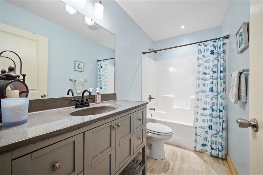 148 1st Street Georgetown, PA 15043 - Photo 17 of 48 a bathroom with a granite countertop sink a toilet a mirror a shower and vanity