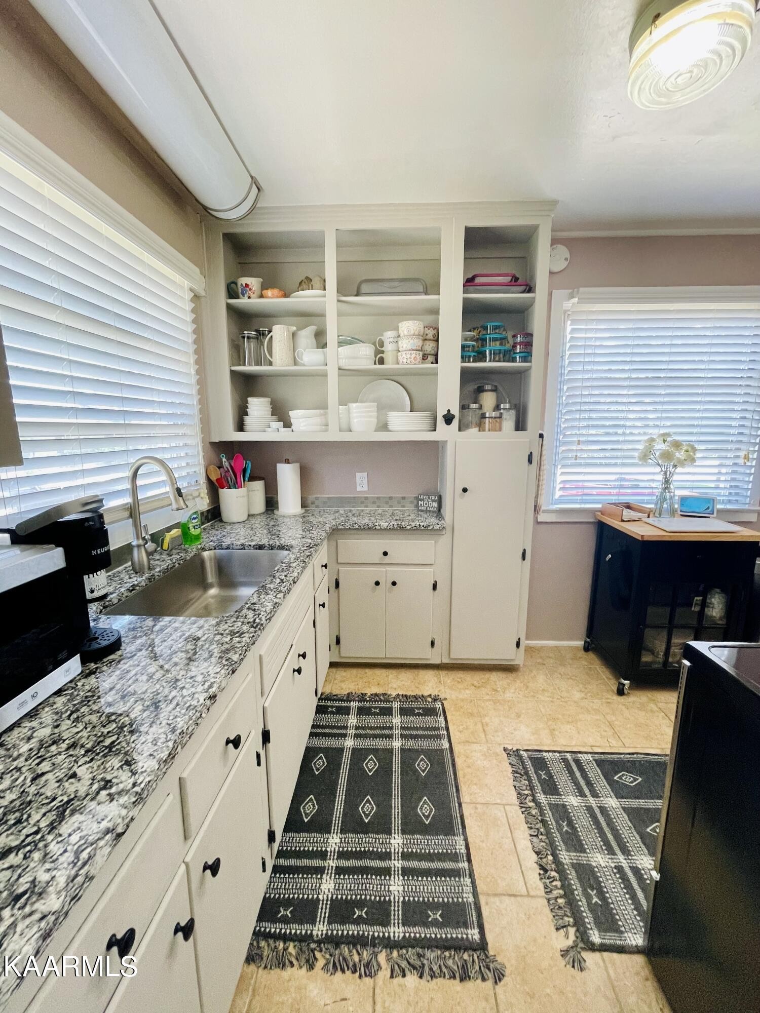 101 Norton Road Oak Ridge, TN 37830 - Photo 19 of 29 a kitchen with granite countertop a sink and a stove