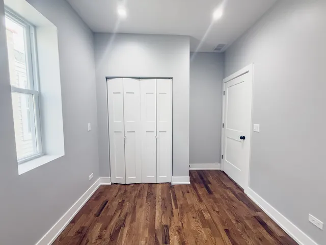 a view of a room with wooden floor and window