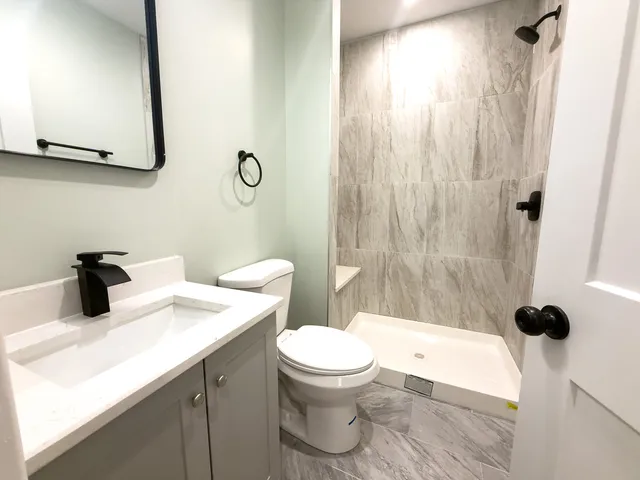 a bathroom with a sink a toilet and shower curtain