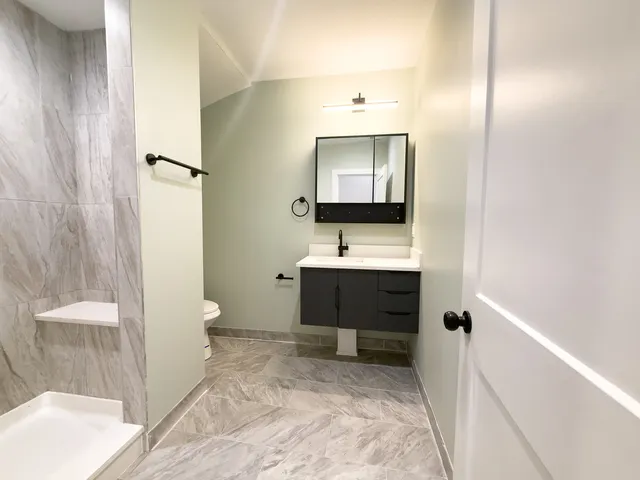 a bathroom with a sink toilet and shower
