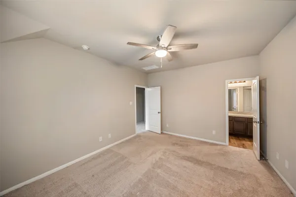 an empty room with closet and windows