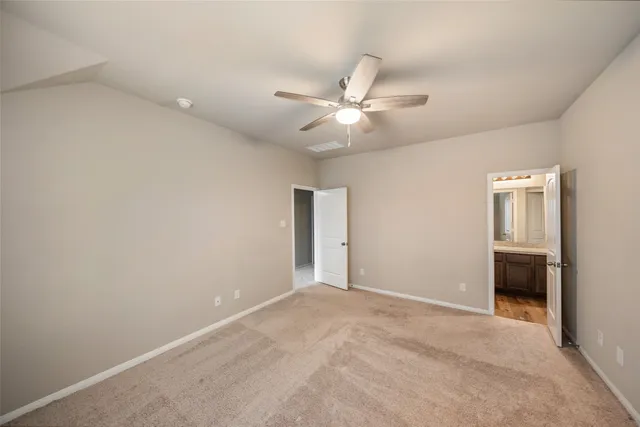 an empty room with closet and windows
